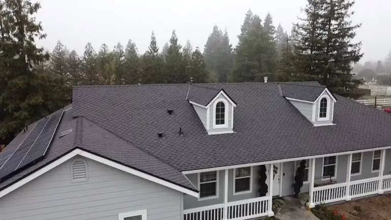 Completed shingle roof with rooftop solar by NuShake Roofing