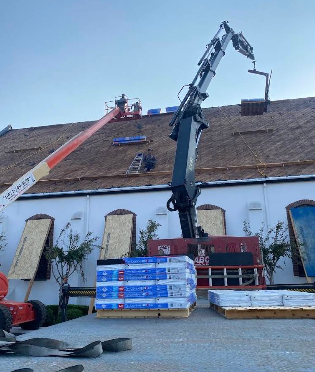 Residential home with new roof installed and company poster in yard